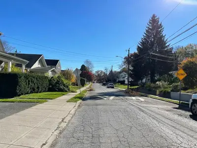 an empty street in a residential neighborhood with a stop sign at Modern Home off I-95 Perfect for Families & Business Stay with Ample Parking in Stamford