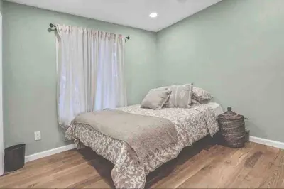a bedroom with a bed and a window at 3 Bedroom Hilltop Escape with 5 Private Acres and Hot Tub in Marlboro