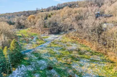 an aerial view of a dirt road in a forest at 3 Bedroom Hilltop Escape with 5 Private Acres and Hot Tub in Marlboro