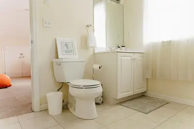 a bathroom with a white toilet and a shower at Urban Downtown Stamford Home 45 min to NYC with Garage And Yard in Stamford
