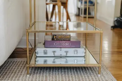 a stack of books on a glass shelf at Urban Downtown Stamford Home 45 min to NYC with Garage And Yard in Stamford