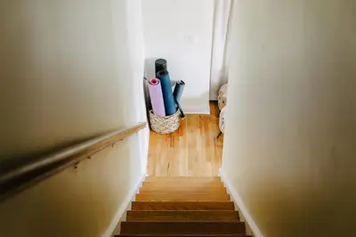 a hallway with a stairway with a pot of scissors at Urban Downtown Stamford Home 45 min to NYC with Garage And Yard in Stamford