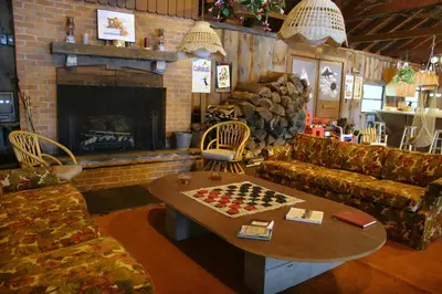 a living room with a chess table and a fireplace at Captains Cabin - Cozy Cabin in Laurel Island in East Hampton