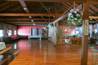 a large room with a table and flowers hanging from the ceiling at Captains Cabin - Cozy Cabin in Laurel Island in East Hampton