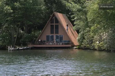 a house on a dock in the middle of a lake at Captains Cabin - Cozy Cabin in Laurel Island in East Hampton
