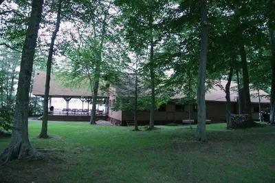 a group of trees in front of a building at Cabin Chalet - Breathtaking Cabin in Laurel Island in East Hampton