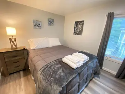 a bedroom with a bed with towels on it at Double Play Apt 2 All Star Baseball Rentals in Oneonta