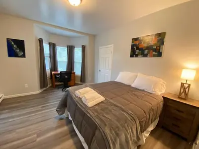 a bedroom with a bed and a desk in a room at Double Play Apt 2 All Star Baseball Rentals in Oneonta