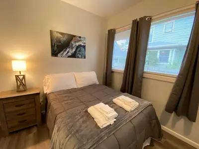 a bedroom with a bed with two towels on it at Double Play Apt 2 All Star Baseball Rentals in Oneonta