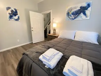 a bedroom with a large bed with two towels on it at Double Play Apt 2 All Star Baseball Rentals in Oneonta
