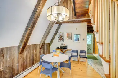 a dining room with a table and chairs at A-Frame Cabin with Furnished Deck in Becket! in Becket