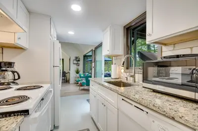 a kitchen with white cabinets and a stove at South Salem Vacation Rental with Furnished Deck! in South Salem