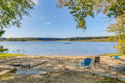 a group of chairs sitting on the shore of a lake at South Salem Vacation Rental with Furnished Deck! in South Salem