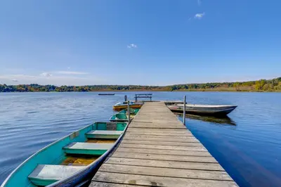 a group of boats tied to a dock on a lake at South Salem Vacation Rental with Furnished Deck! in South Salem