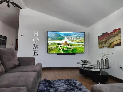 a living room with a flat screen tv on the wall at little cozy house in a village in Mountain Dale