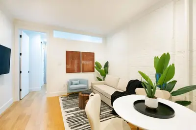 a living room with a couch and a table at 1290-7 New Renovated 2 Bedrooms in UES in New York