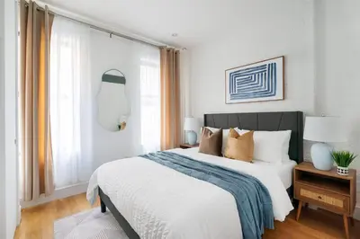 a bedroom with a large bed and a window at 1290-7 New Renovated 2 Bedrooms in UES in New York