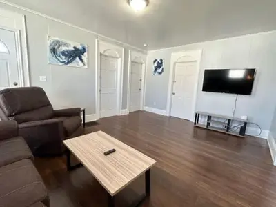a living room with a couch and a coffee table at Home Plate Apt 1 All Star Baseball Rentals in Oneonta