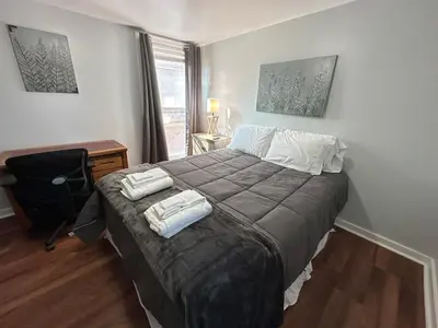 a bedroom with a bed with two towels on it at Home Plate Apt 2 All Star Baseball Rentals in Oneonta