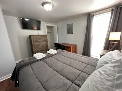 a bedroom with a large bed and a window at Home Plate Apt 2 All Star Baseball Rentals in Oneonta