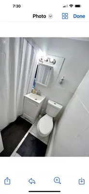 a bathroom with a white toilet and a sink at 4-A Diamond in Yonkers in Yonkers