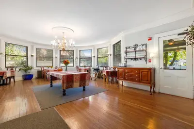 a dining room and living room with a table and chairs at DeBary Inn in Summit