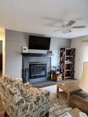 a living room with a couch and a fireplace at Mt Snow Condo with Pool Mountain Views Half Mile to Mtn in Dover