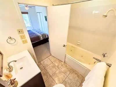 a bathroom with a tub and a sink and a shower at Mt Snow Condo with Pool Mountain Views Half Mile to Mtn in Dover