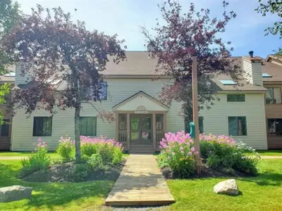 a house with a pathway leading to the front door at Mt Snow Condo with Pool Mountain Views Half Mile to Mtn in Dover