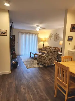 a living room with a couch and a table at Mt Snow Condo with Pool Mountain Views Half Mile to Mtn in Dover