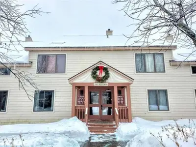 a house with a wreath on the front door at Mt Snow Condo with Pool Mountain Views Half Mile to Mtn in Dover