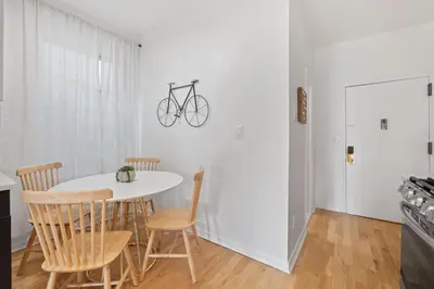 a dining room with a white table and chairs at Jersey City Monthly Boutique 20 Min to NYC in Jersey City