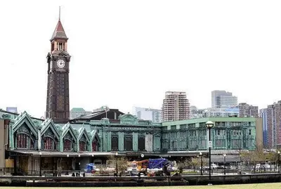 a large building with a clock tower in a city at Spacious Oasis - Hoboken California King Bed! in Hoboken