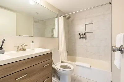 a bathroom with a toilet and a sink and a shower at XL Center 1-BR Condo DWNTN Hartford Easy Parking in Hartford