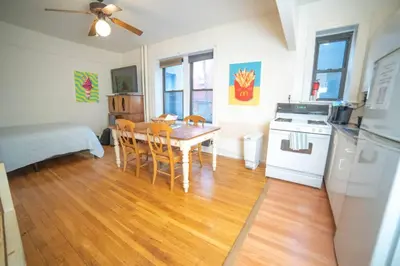 a kitchen and dining room with a table and chairs at Cozy apartment in beautiful midtown Hoboken in Hoboken