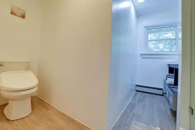 a bathroom with a toilet and a window at Rustic Bainbridge Retreat with Spacious Yard! in Bainbridge