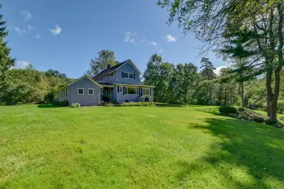 a house on a large yard with a large grassy field at Rustic Bainbridge Retreat with Spacious Yard! in Bainbridge
