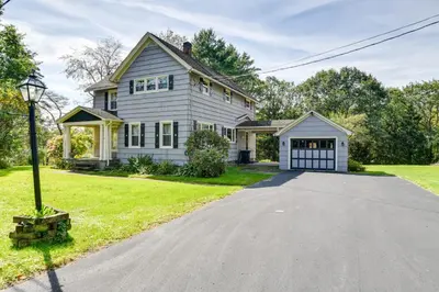 a white house with a garage and a driveway at Rustic Bainbridge Retreat with Spacious Yard! in Bainbridge