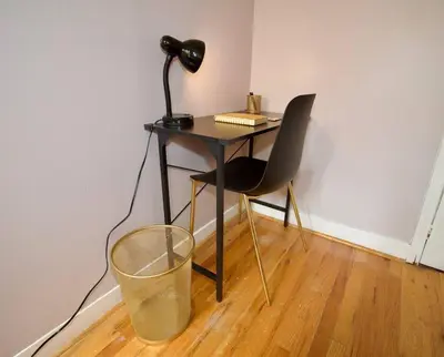a desk with a chair and a lamp and a trash can at Tuk Ahoy - Sunset Suite (3B) with Shared Spaces in Brooklyn