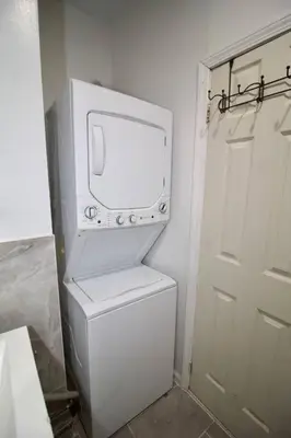 a white washer and dryer in a small bathroom at Tuk Ahoy - Sunset Suite (3B) with Shared Spaces in Brooklyn