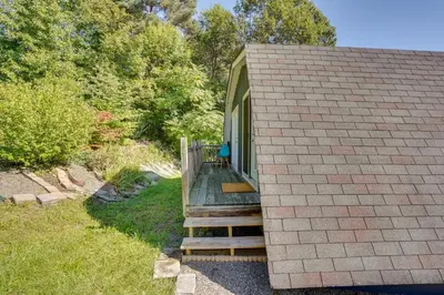 a small house with a wooden ramp leading to a porch at Charming Claverack Retreat with Serene Deck! in Claverack