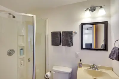 a bathroom with a toilet and a sink and a mirror at Charming Claverack Retreat with Serene Deck! in Claverack