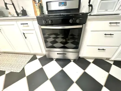 a kitchen with a black stove and a microwave at 5-A Diamond in Yonkers in Yonkers