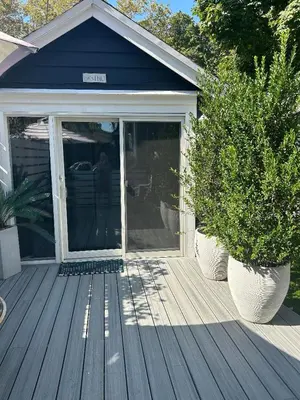 a porch with two potted plants on a house at Adorable 1 bedroom cottage in Forest Hills