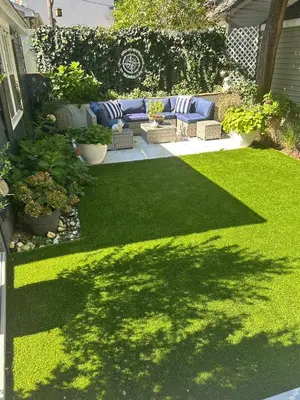 a yard with a blue couch and green grass at Adorable 1 bedroom cottage in Forest Hills