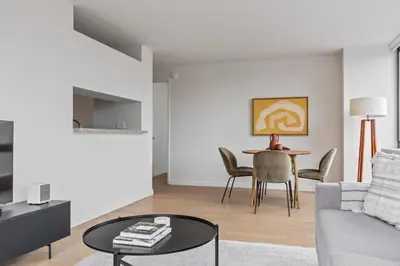 a living room with a couch and a table at UWS 2BR w Elevator Gym DM Playroom Rooftop NYC-868 in New York