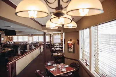 a dining room with tables and chairs in a restaurant at Luxury getaway in woods, Jacuzzi, Hot Tub, Pool in Bushkill