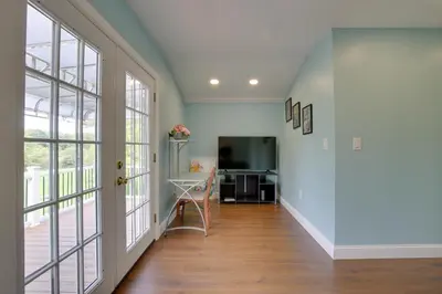 a hallway with a desk and large windows at Fire Pit and On-Site Pond Hudson Valley Home! in Wappingers Falls