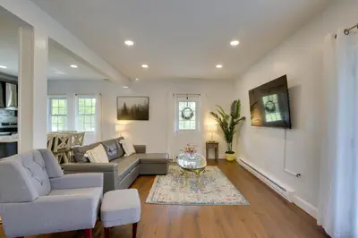 a living room with a couch and a table at Fire Pit and On-Site Pond Hudson Valley Home! in Wappingers Falls