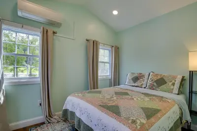 a bedroom with a bed and a window at Fire Pit and On-Site Pond Hudson Valley Home! in Wappingers Falls